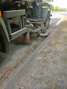 A road sweeper vehicle in action.