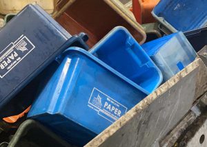 Unwanted recycling boxes on a conveyor belt that takes them to be shredded.