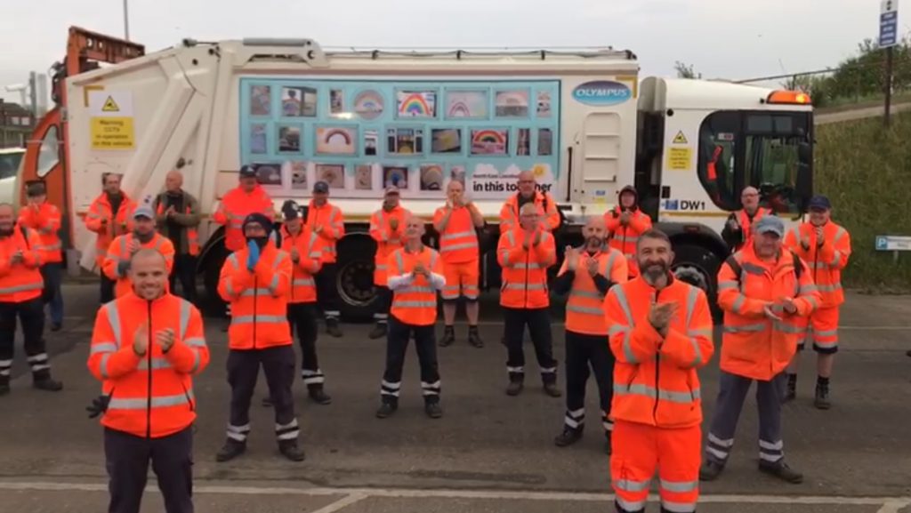 Refuse workers clapping in front of a wagon at Gilbey Road depot in Grimsby