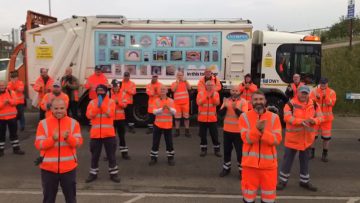 Refuse workers clapping in front of a wagon at Gilbey Road depot in Grimsby