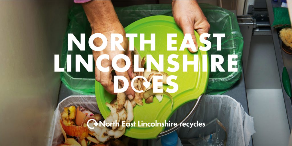 Someone scraping potato peelings into a food waste bin