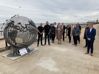 Sponsor representatives gather for the ribbon cutting of the new recycling globe in Cleethorpes.