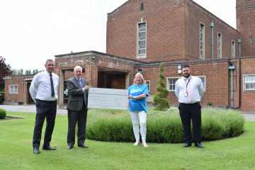 A photo of representatives from Grimsby Crematorium presenting a cheque to Parkinsons UK.