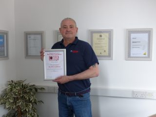 Darren from Mayne Gas Heating holding his Buy With Confidence certificate