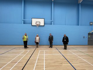 Members of the project group post for a photo in the newly refurbished sports hall