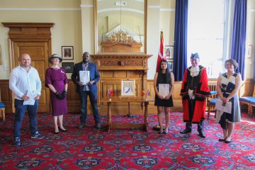 A photo of the Mayor and DLL presenting certificates in recognition of British Citizenship