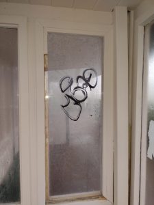 Graffiti tag on Kingsway shelter window in Cleethorpes.