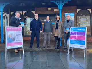 Image shows Cllr Ron Shepherd (NELC), Quinn Needham, John Smith and Sally Johnston (HEY Credit Union), with Derek O'Connell (Lincs Inspire) outside Cleethorpes Library. 