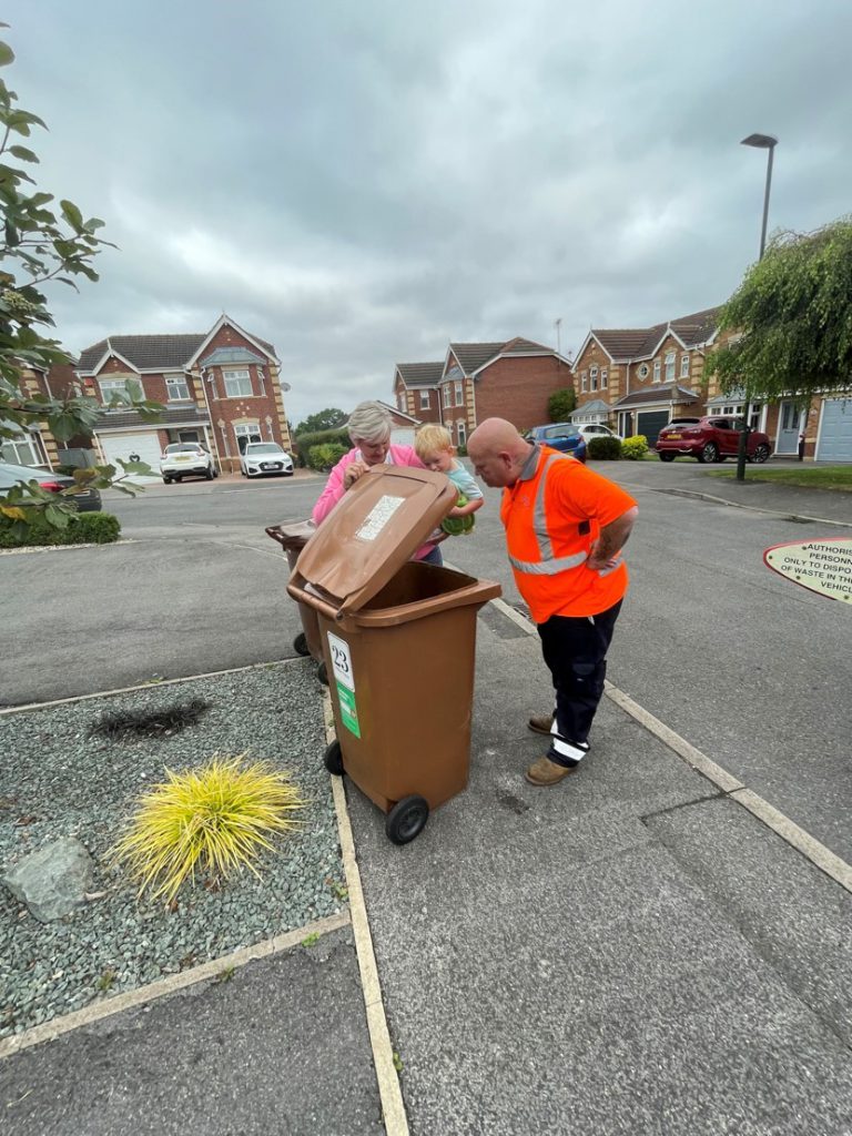 Mason inspects the bin with Nik