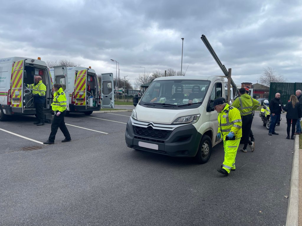 Officers inspecting a white van