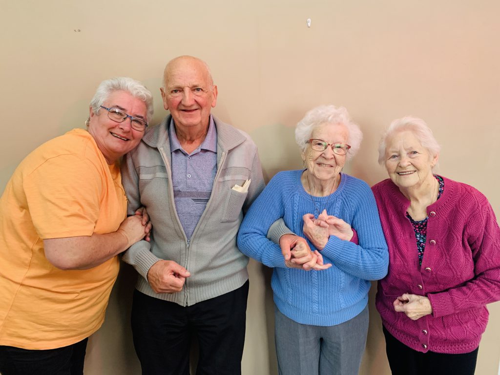 A photograph of Friendship at Home users Tina and Keith Mitchell, Ruby Jackson, and June Dadd