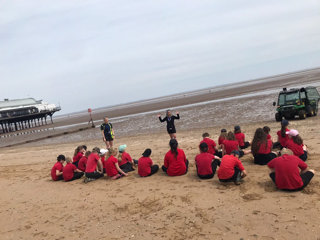 Resort management team speaking with school children