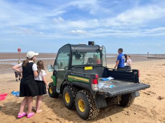 School children take a look at the resort team beach buggy