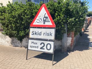 skid risk roadworks sign