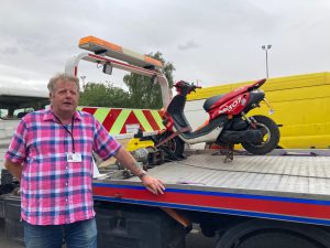 Cllr Ron Shepherd with the scooter seized during the day of action in Scartho Road