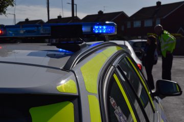 Police car parked up with police officer