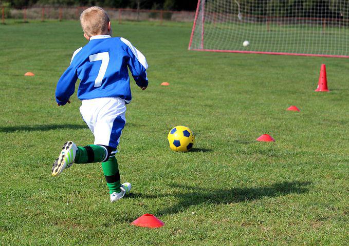 Young boy chasing a football