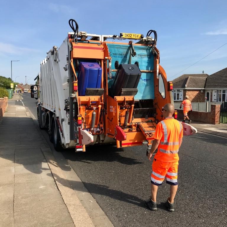 waste crew worker emptying bins