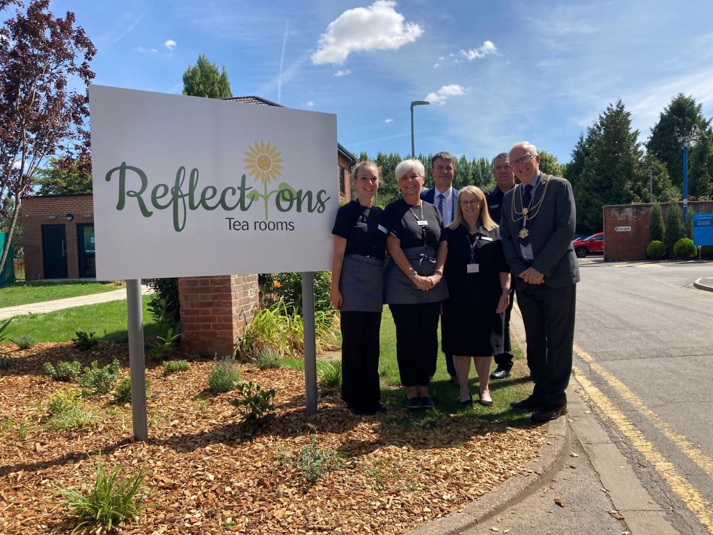 Councillors and staff at the entrance to the new tea room at the Crematorium.