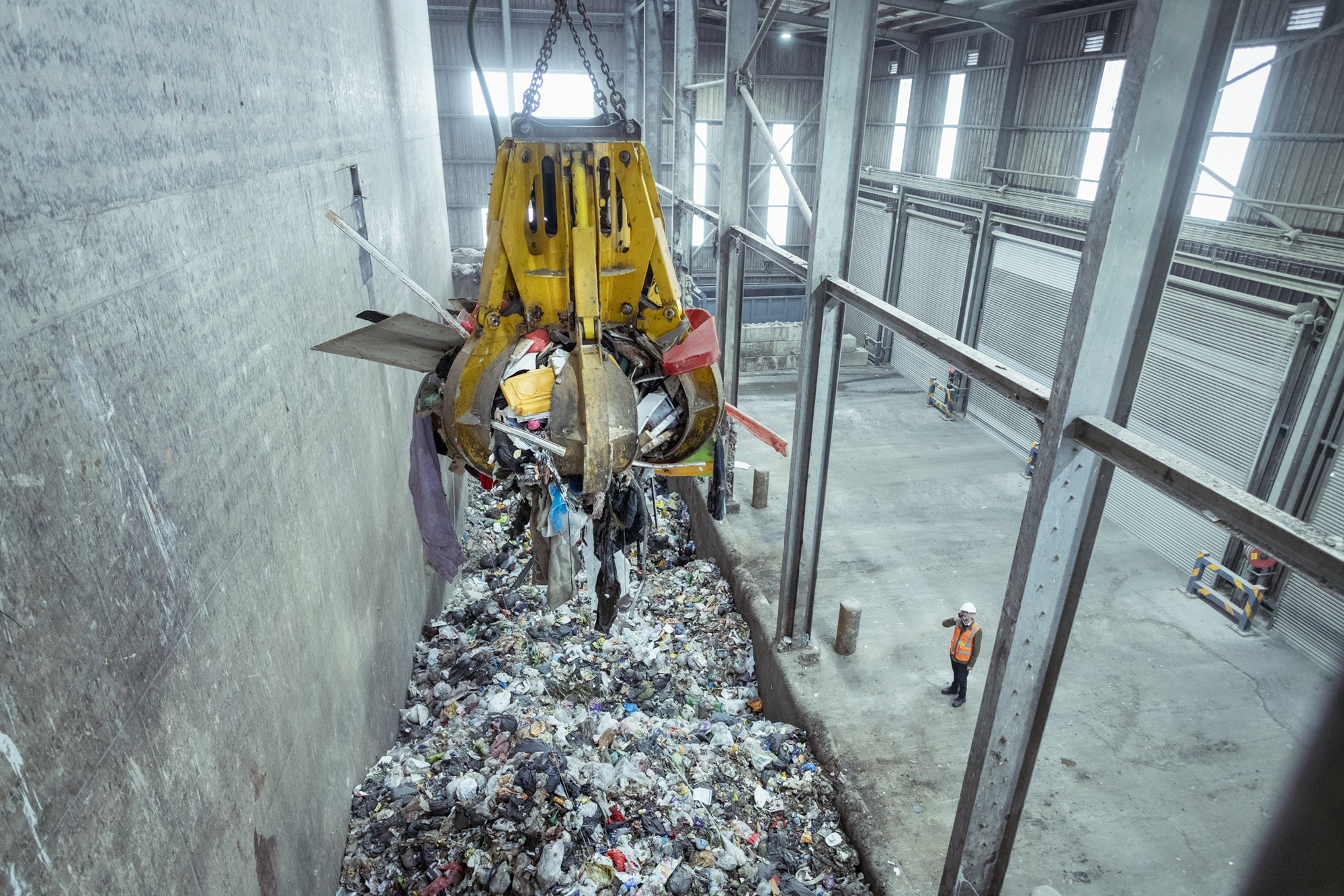 A grabber takes the waste and empties into a hopper