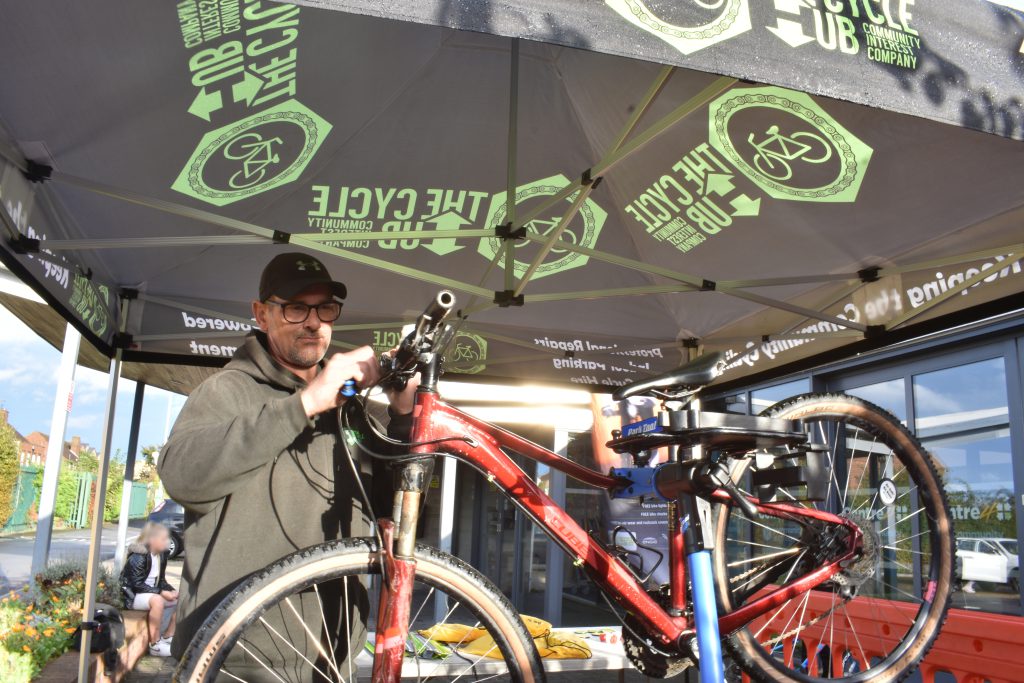 Man fixing bike at Be Safe, Be Seen event