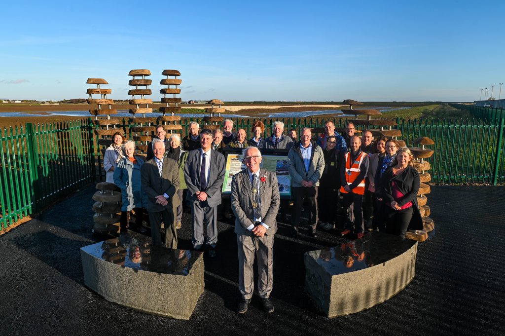 Novartis Ings - group photograph comprising representatives from the nature partnerships and professionals who created the site, Novartis, funding partners (Greater Lincolnshire LEP and ERDF), North East Lincolnshire Council and EQUANS, as well as the family members mentioned in the story
