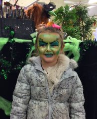 A young girl with her face painted.