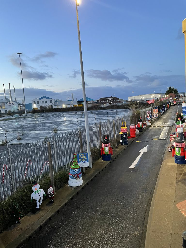 Characters lining the Grimsby Tip entrance road