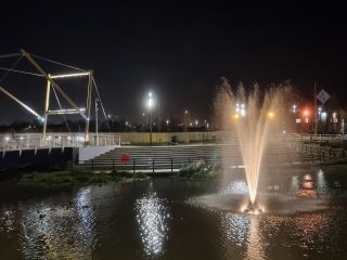 Fountain in the River Freshney in the foreground with the bridge to Garth Lane behind