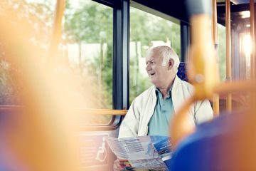 A stock photo of an elderly man on a bus.