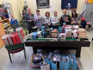 A photo of the Saying Close team with their boxes of presents