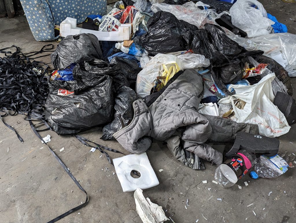 A coat and other rubbish pulled from the load of paper and card before it was sent to the recycling plant