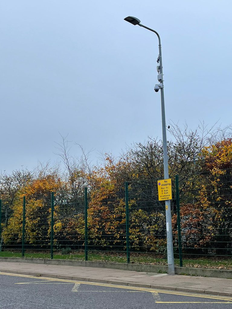 A photo of a lamppost with CCTV cameras