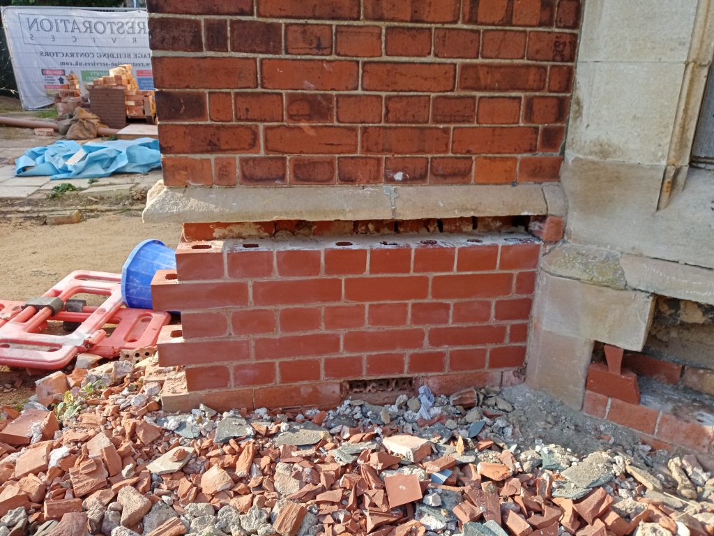 Restoration of brickwork panels with new bricks in place
