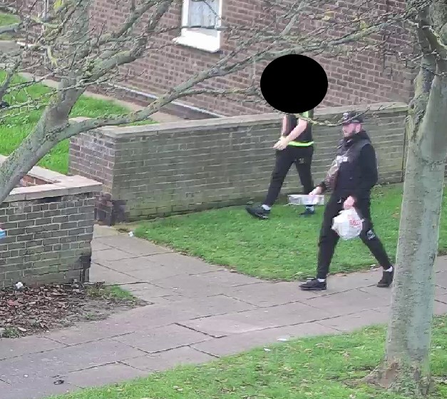 A man carrying a bag of rubbish