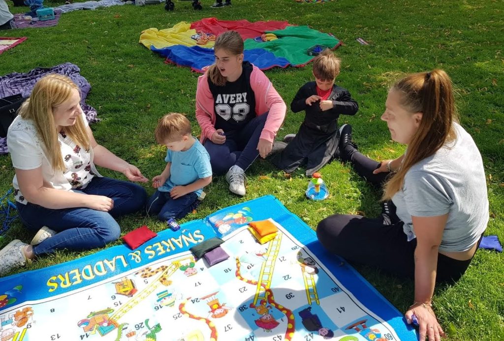 A photo of some mums in the park with their children