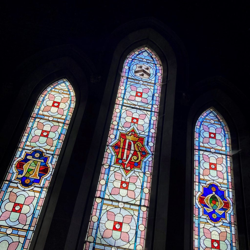 Stained glass windows inside the Scartho Cemetery Chapels. One of the panes has the Grimsby Town coat of arms with three hog's heads.