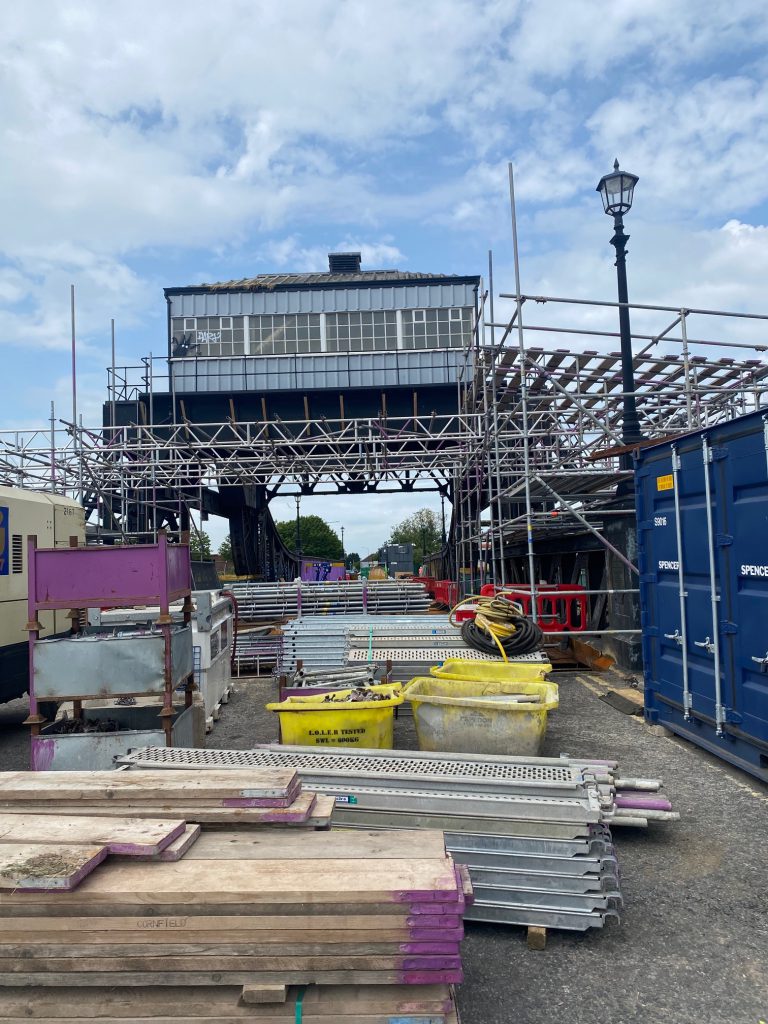 Corporation Bridge works with various materials on the bridge and scaffolding