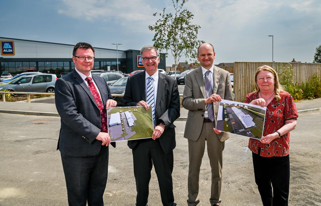 Councillor Margaret Cracknell, Portfolio Holder for Children and Education at North East Lincolnshire Council, with Lincolnshire Gateway Academies Trust Executive Principal Andy Clark, Chair Philip Bond and Chief Executive Officer Martin Brown. They hold paper plans of the schools.