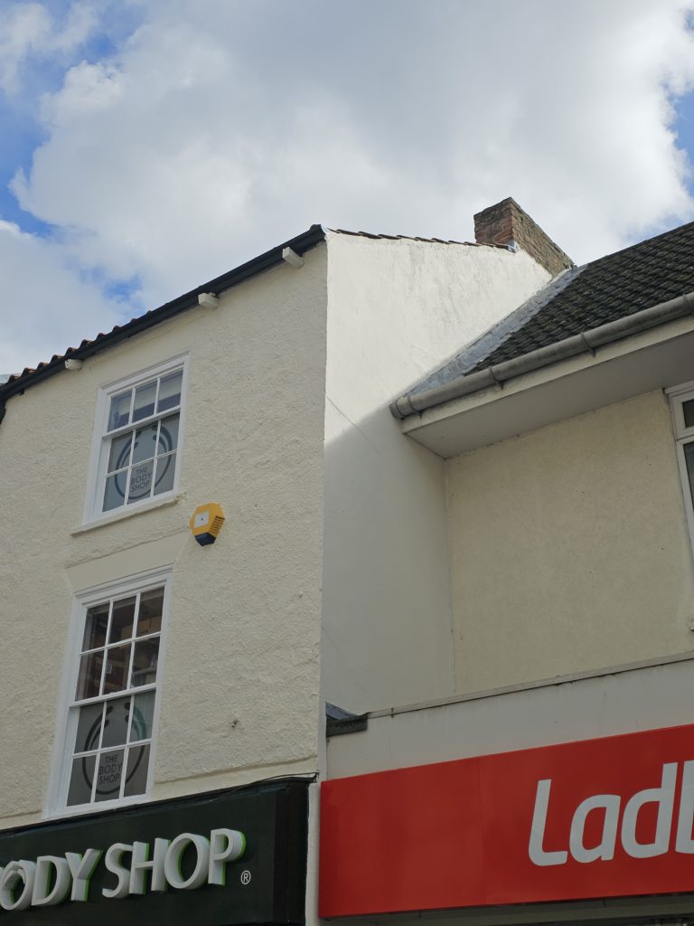 Freshly painted and repaired render on a Grimsby shop front