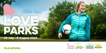 A girl with a football in a park.