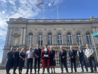 A photo of the Mayor and dignitaries at the Town Hall