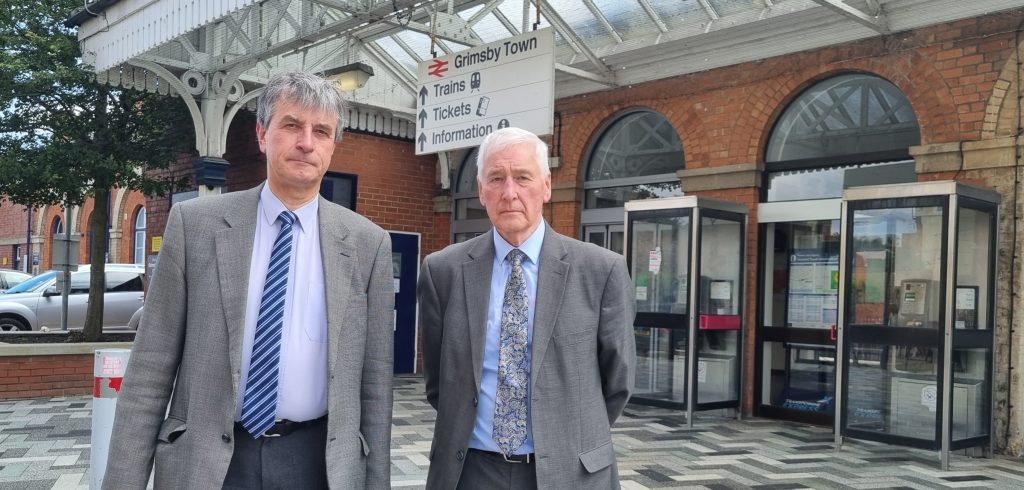 Photo of the Leader and Councillor Swinburn outside Grimsby Train Station