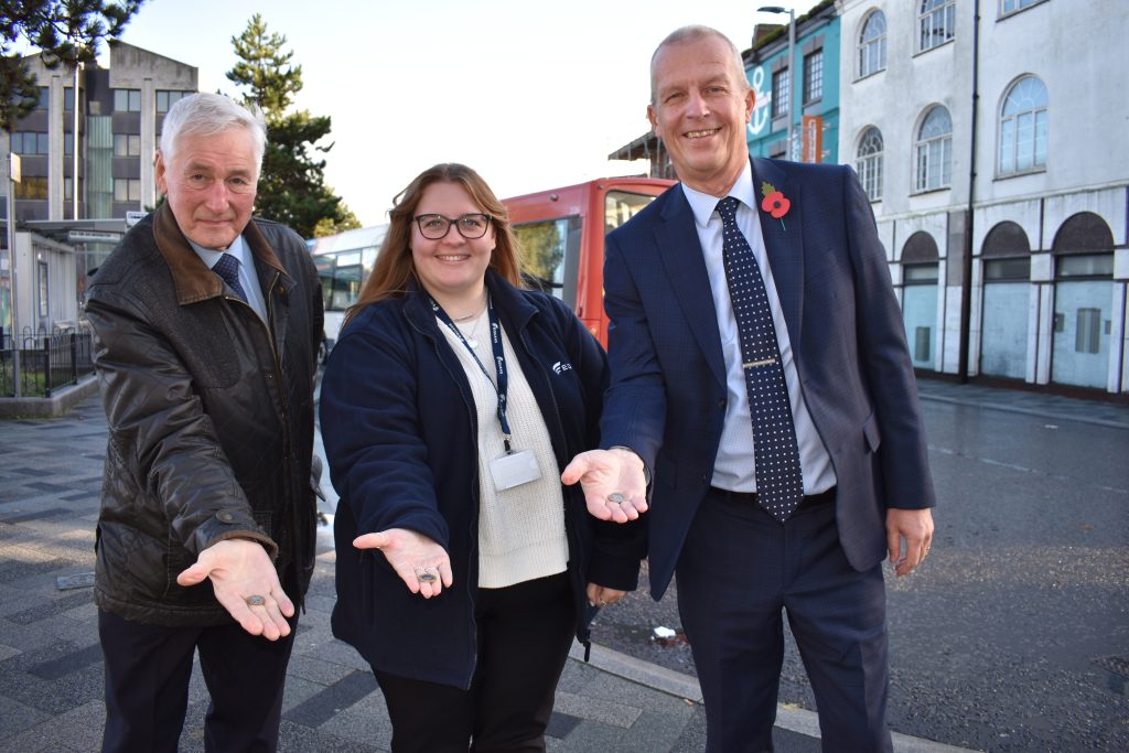 Councillor Swinburn, Lani Lamming and Dave Skepper look to the camera holding a £1 coin.