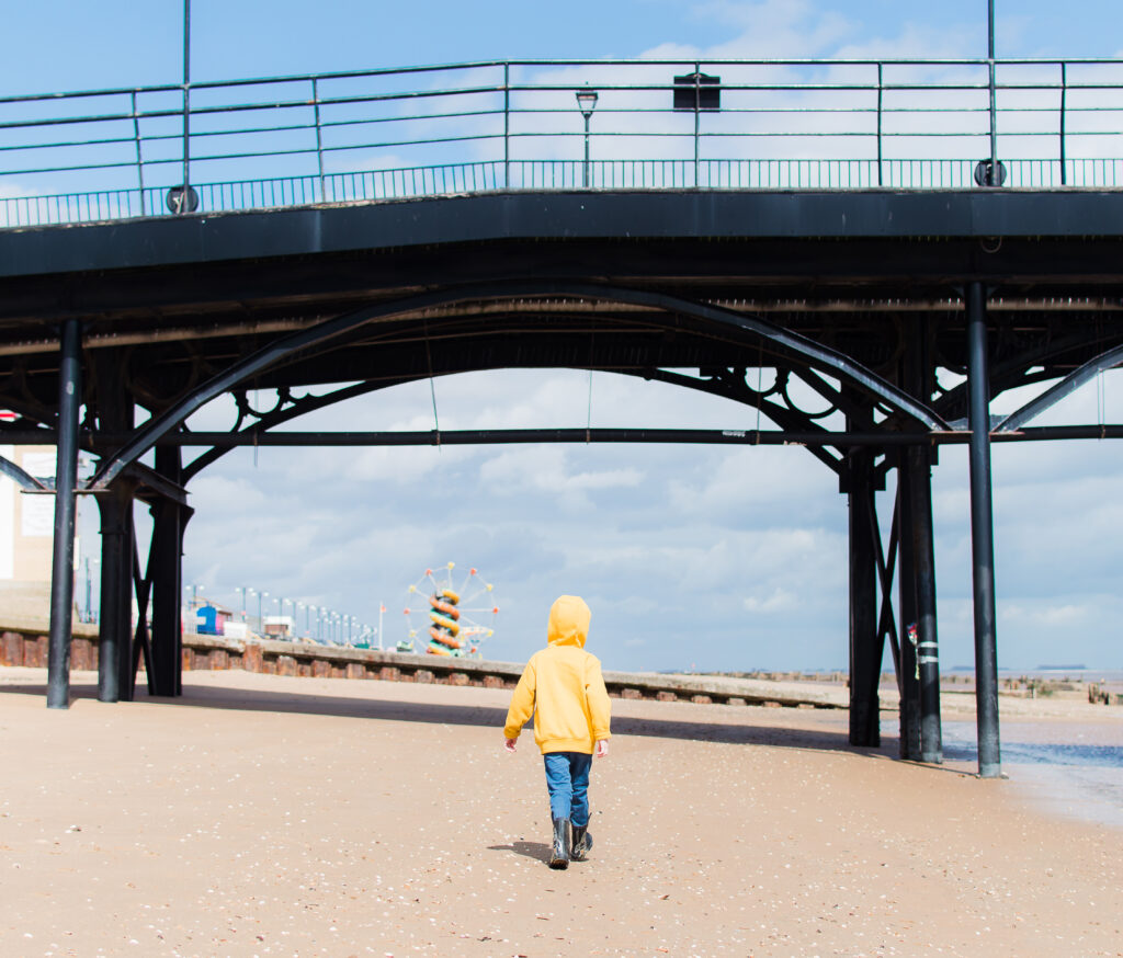 Boy in yellow hoody on the beach