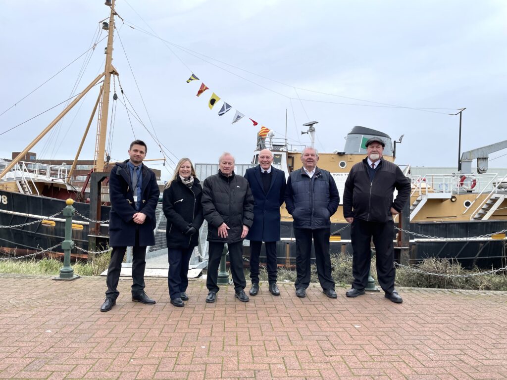 Ross Tiger reopens on 28 March. Group of people stand in front of the ship.