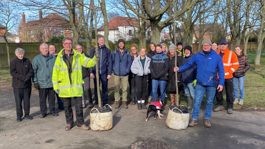 Group photo of volunteers and school children planting trees in Haverstoe Park, Cleethorpes