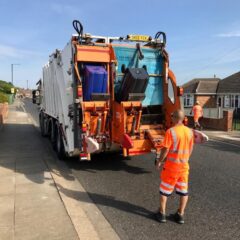 Bin crews emptying a bin lorry on a residential road