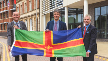 A photo of the three Council Leaders with a Lincolnshire flag