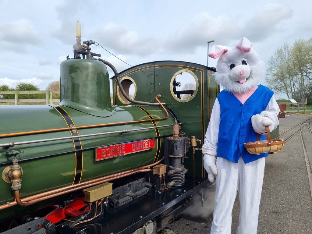 A person dressed as the Easter bunny stood in front of a train at Cleethorpes Coast Light Railway